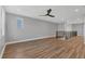 Bright living room with hardwood floors, ceiling fan, and large window offers a spacious design at 5833 Millennium Silver Ct, Sarasota, FL 34238