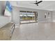 Bright living room features large sliding glass doors offering stunning views of the lanai and pool at 5833 Millennium Silver Ct, Sarasota, FL 34238