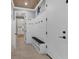 Organized mudroom with built-in bench, hooks, and shelving for storage at 5833 Millennium Silver Ct, Sarasota, FL 34238