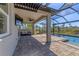 Relaxing covered patio featuring stone floors, a ceiling fan, outdoor seating, and pool access with beautiful backyard views at 5833 Millennium Silver Ct, Sarasota, FL 34238