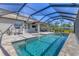 Inviting screened-in pool and spa with a sun deck, offering a refreshing oasis in the backyard at 5833 Millennium Silver Ct, Sarasota, FL 34238