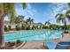 Community pool surrounded by brick patio, clear blue water, and lush landscaping at 5833 Millennium Silver Ct, Sarasota, FL 34238