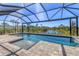 Relaxing screened-in pool with a scenic view of the surrounding nature and pond at 5833 Millennium Silver Ct, Sarasota, FL 34238