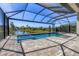 Beautiful screened-in pool and spa overlooking a serene pond and lush greenery, perfect for outdoor enjoyment at 5833 Millennium Silver Ct, Sarasota, FL 34238