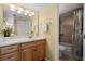 This bathroom features a wooden vanity, a tile shower with a tub, and good lighting at 5855 Midnight Pass Rd # 204, Sarasota, FL 34242
