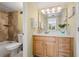Bright bathroom featuring a wooden vanity, a neutral countertop, and tile flooring throughout at 5855 Midnight Pass Rd # 204, Sarasota, FL 34242