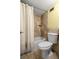 Cozy bathroom with a shower/tub combo, tiled walls, and a functional toilet at 5855 Midnight Pass Rd # 204, Sarasota, FL 34242