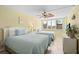 This bedroom has two twin beds, a ceiling fan, and bright natural light coming through the plantation shutters at 5855 Midnight Pass Rd # 204, Sarasota, FL 34242