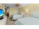 The bedroom includes twin beds, a ceiling fan, and a view of the bathroom at 5855 Midnight Pass Rd # 204, Sarasota, FL 34242