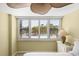 The bright bedroom overlooks a pool with plantation shutters and a ceiling fan at 5855 Midnight Pass Rd # 204, Sarasota, FL 34242