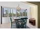 Cozy dining area with a unique light fixture and natural light from the window at 5855 Midnight Pass Rd # 204, Sarasota, FL 34242