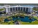 Birds eye view of the building featuring a serene blue pond, parking, and manicured grounds at 5855 Midnight Pass Rd # 204, Sarasota, FL 34242