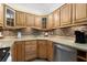Cozy kitchen featuring wooden cabinets, stainless steel appliances, and a decorative backsplash at 5855 Midnight Pass Rd # 204, Sarasota, FL 34242