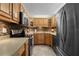 The kitchen shows stainless steel appliances, beautiful wooden cabinets, and tiled backsplash at 5855 Midnight Pass Rd # 204, Sarasota, FL 34242