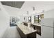 Bright community kitchen space with a spacious island, stainless steel appliances, and great natural light at 5855 Midnight Pass Rd # 204, Sarasota, FL 34242