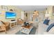 Comfortable living room featuring beach-themed decor, tile floors, and a cozy seating arrangement at 5855 Midnight Pass Rd # 204, Sarasota, FL 34242