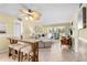 Open-concept living room with dining and seating areas under a unique ceiling fan fixture at 5855 Midnight Pass Rd # 204, Sarasota, FL 34242