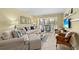 Well-lit living room with comfortable seating, a dining area, and neutral decor at 5855 Midnight Pass Rd # 204, Sarasota, FL 34242