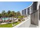 Enjoy an aerial view of the pool and grilling area from the balcony at 5855 Midnight Pass Rd # 204, Sarasota, FL 34242