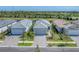 New construction homes showing the community's appealing landscaping, brick-paved driveways, and serene water view at 6260 Fish Eagle Ct, Nokomis, FL 34275
