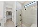 Modern bathroom with glass enclosed shower and access to a large walk-in closet space at 6260 Fish Eagle Ct, Nokomis, FL 34275