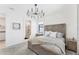 Cozy bedroom boasts plush carpet, a modern chandelier, and stylish furnishings for a relaxing ambiance at 6260 Fish Eagle Ct, Nokomis, FL 34275