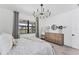 Bright bedroom with a decorative light fixture and a large window, showcasing a peaceful retreat at 6260 Fish Eagle Ct, Nokomis, FL 34275