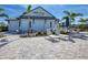 Beautiful Hideaway Bar & Grille with outdoor seating area and lush tropical landscaping at 6260 Fish Eagle Ct, Nokomis, FL 34275