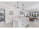 Modern kitchen island with white cabinets and quartz countertops, great for food prep and entertaining at 6260 Fish Eagle Ct, Nokomis, FL 34275