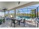 Enjoy outdoor living in this screened lanai with a pool, water view, outdoor dining and sitting areas at 6260 Fish Eagle Ct, Nokomis, FL 34275