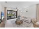 Bright living room featuring a neutral color palette, tile floors, and sliding glass doors to outdoor space at 6260 Fish Eagle Ct, Nokomis, FL 34275
