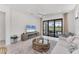 Comfortable living room with fireplace, sleek ceiling fan, and view to backyard at 6260 Fish Eagle Ct, Nokomis, FL 34275