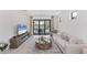 Stylish living room with cozy furniture, tile floors, and scenic outdoor views through sliding glass doors at 6260 Fish Eagle Ct, Nokomis, FL 34275
