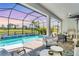 Screened-in lanai with a private pool and water feature overlooking a serene lake and beautiful sunset at 6260 Fish Eagle Ct, Nokomis, FL 34275