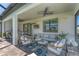 Comfortable covered outdoor patio featuring stylish seating, ceiling fan, outdoor kitchen, and serene backyard views at 6260 Fish Eagle Ct, Nokomis, FL 34275