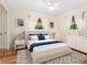 Bright staged bedroom features blue accent decor, a ceiling fan, and views to the trees outside of the window at 6308 Caracara St, Sarasota, FL 34241