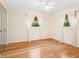 An empty bedroom provides a blank canvas, illuminated with natural light through bright windows and hardwood floors at 6308 Caracara St, Sarasota, FL 34241