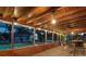 Inviting covered patio with wood ceiling, string lights, and bar area overlooking the sparkling pool at 6308 Caracara St, Sarasota, FL 34241