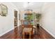 Bright dining room with wood table, chairs, modern light fixture and a view of the pool at 6308 Caracara St, Sarasota, FL 34241