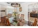 Dining area with wood table, chairs, modern light fixture and kitchen view at 6308 Caracara St, Sarasota, FL 34241