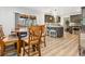 Open dining area adjacent to kitchen with breakfast bar, featuring wood table and chairs, plus view of screened patio at 6308 Caracara St, Sarasota, FL 34241