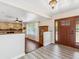 Inviting foyer featuring a stone fireplace, hardwood floors, a ceiling fan, and a decorative stained-glass front door at 6308 Caracara St, Sarasota, FL 34241