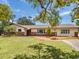 Attractive single-story home with a well-kept lawn, tasteful landscaping, brick walkway, and neutral exterior at 6308 Caracara St, Sarasota, FL 34241