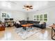 Bright living room with a large sectional sofa, wooden coffee table, tile flooring, and multiple windows with natural light at 6308 Caracara St, Sarasota, FL 34241