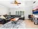 Inviting living room featuring large sectional sofa, a wooden coffee table, tile floors, and views from bright windows at 6308 Caracara St, Sarasota, FL 34241