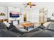 Cozy living room with a large sectional sofa, a modern coffee table, and a TV mounted above a console table at 6308 Caracara St, Sarasota, FL 34241