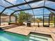Inviting screened pool area with a barbecue grill and easy access from the main house at 6308 Caracara St, Sarasota, FL 34241