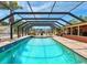 Large, screened pool area with ample patio space, ideal for entertaining and relaxation at 6308 Caracara St, Sarasota, FL 34241