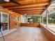 Spacious screened-in sunroom with tile flooring, wood-paneled walls, and a view of the backyard at 6308 Caracara St, Sarasota, FL 34241