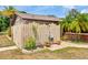 Backyard outdoor shower with privacy fence and tropical landscaping, perfect for rinsing after a swim at 6308 Caracara St, Sarasota, FL 34241